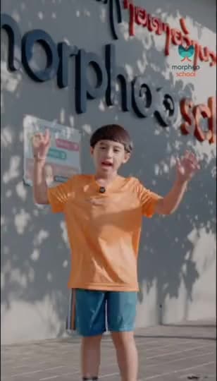 A pupil in an orange Morphoo School T-shirt shows his school: the entrance, the football pitch, the basketball court, the swimming pool, the computer room, the cooking class and a classroom, with his own words as captions, ending on the Morphoo School logo